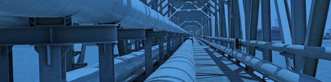 Some pipes under a bridge with a blue overlay